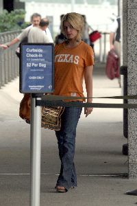 Pictures of Jessica Simpson wearing an orange t-shirt checking her tummy