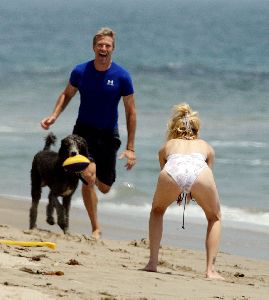 Actress Heather Locklear playing with her dog on the beach pictures