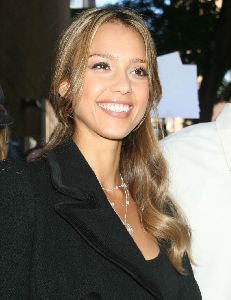 Jessica Alba at an event wearing a black suit and silver accessories