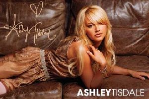 Ashley Tisdale signiture on a photo shoot while resting on a brown couch