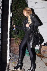 Sexy Lindsay Lohan wearing a black Leggings with black boots pictures