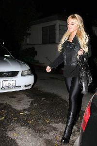 Sexy Lindsay Lohan wearing a black Leggings with black boots pictures