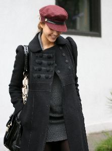 Jessica Alba wearing a black coat and a red rose hat in Los Angeles on December 18th 2007