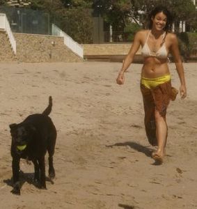 Michelle Rodriguez on the beach with her dog