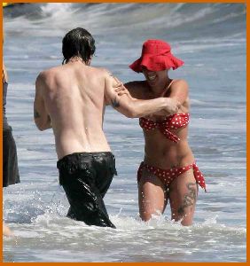 Pink in a red bikini and hat swimming at the beach in Malibu on April 12th 2008