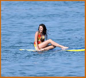 Miley Cyrus on the beach with friends while filming the new Hannah Montana movie in Malibu in July 2008