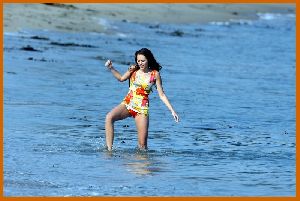 Miley Cyrus on the beach with friends while filming the new Hannah Montana movie in Malibu in July 2008