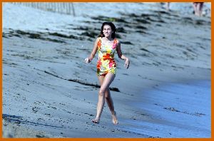 Miley Cyrus on the beach with friends while filming the new Hannah Montana movie in Malibu in July 2008