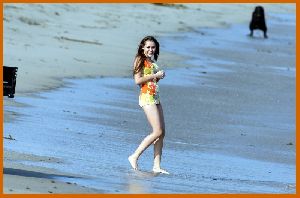 Miley Cyrus on the beach with friends while filming the new Hannah Montana movie in Malibu in July 2008