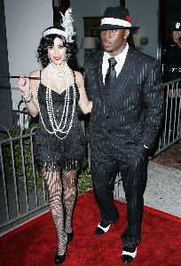 Kim Kardashian : kim picture wearing a feather hat with her boyfriend at the Pur Jeans Halloween Bash