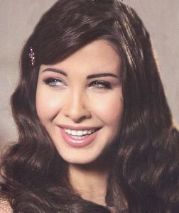 Nancy Ajram : nancy smiling to the camera of mirna khayyat the director of moshtaga leek video clip