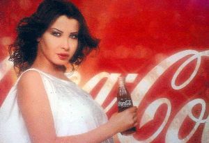 Nancy Ajram : the coca cola ad poster of nancy with the drink bottel in hand