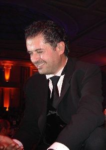 Ragheb Alama : in a black suit on stage singing live for his audience