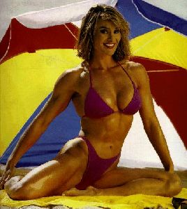 Cory Everson : Corey Everson wearing a pink bikini under a beach umbrella