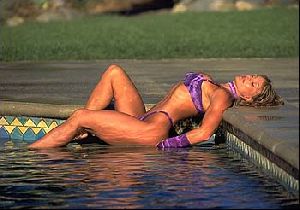 Cory Everson : Cory Everson picture at a swimming pool wearing a purple bikini