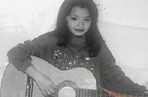 Tila Tequila picture when she was a child with an accoustic guitar