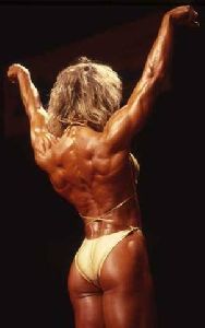 Cory Everson : on stage showing her back perfectly shaped muscles