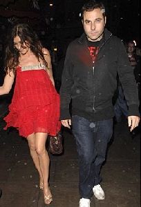 Lisa Snowdon : wearing a short red dress walking with David Walliams hand in hand