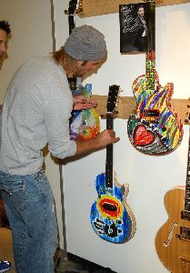 Josh Holloway : hanging his masterpiece colored guitar that will be sold at a Guitar Charity Event