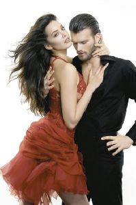 Azra Akin in a stylish red dress hugging her boyfriend Kivanc Tatlitug