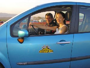 Azra Akin driving a blue racing car