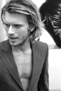 Kivanc Tatlitug wearing a suit jacket over a naked chest