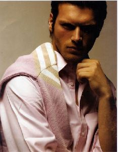 Kivanc Tatlitug wearing a pink shirt