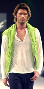 Kivanc Tatlitug wearing a lime green scarf