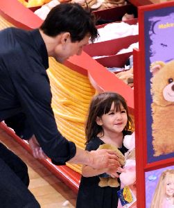 Suri Cruise having a good time playing at a park