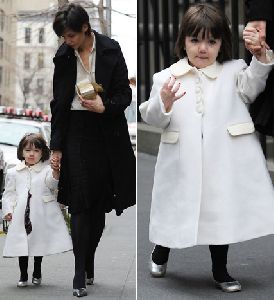 Suri Cruise in a stylish white coat