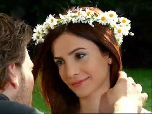 Songul Oden wearing a floral hair band