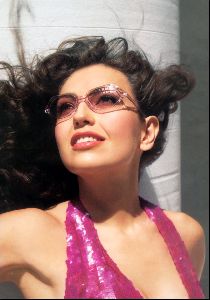 Thalia wearing a light pink shaded sunglasses