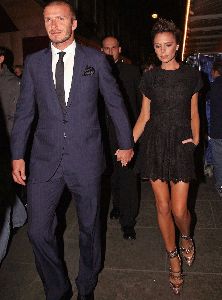 VICTORIA BECKHAM : David wearing an elegant navy suit with his wife Victoria who is wearing a weird high heels golden shoes