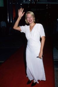 Linda Kozlowski : waving to the fans at a movie premiere wearing a white dress