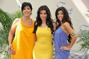 Kourtney Kardashian : with her mother Kris Jenner and sister Kim attend a photocall promoting the television series Keeping Up With the Kardashians on June 11th, 2008