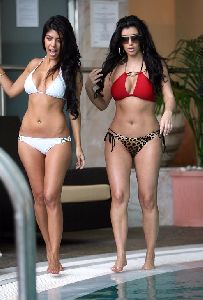 Kourtney Kardashian wearing a white bikini while Kim chose a red one in Monaco on June 12th 2008