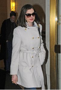 Anne Hathaway : wearing a white double-chest coat over a black skirt heading towards a building in New York City, yesterday s afternoon 5th January 2009