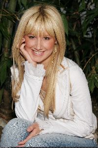 Ashley Tisdale smiling at the camera in a photosession back in 2005