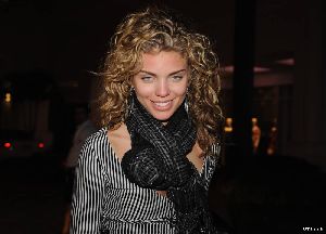 AnnaLynne McCord wearing a zibra-printed jacket and black neck scarf