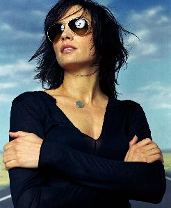 Famke Janssen : wearing a blue stone-gem becklace and large sunglasses