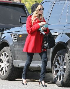 Nicole Richie : out of her car n Beverly Hills wearing a red pea coat, black mini-woolen hat, and high heels in Los Angeles, California on the 6th of January 2009