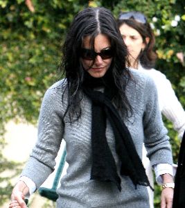 Courtney Cox : Candids in Beverly Hills on January 5th 2009 wearing a gray sweater and a black neck scarf with matching brown-dark shaded sunglasses