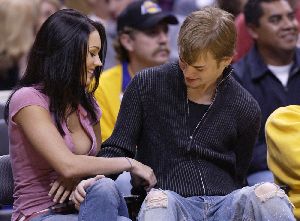 Megan Fox : high quality picture together with David Gallagher at the Lakers Game in 2004 - Megan wearing a purple short-sleeves shirt but keeps it unbuttoned