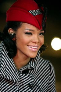 Rihanna striped black and white heavy coat and a red hat