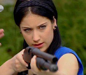 a photo of hazal kaya learning to use the rifle