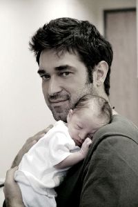 Burak Hakki holding his baby