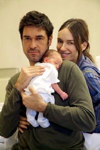 Burak Hakki holding his baby with his wife Sema Simsek