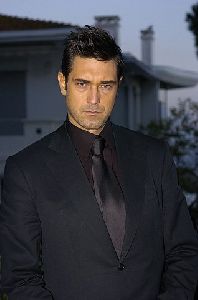 Burak Hakki in a black tuxedo suit