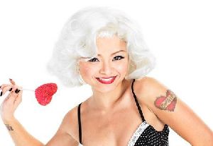 tila tequila : wearing a red-rose lipsticked mached with a wavy short blond wig