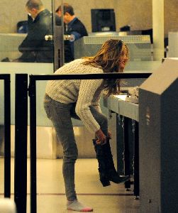 Alessandra Ambrosio : taking her boots off as she goes through security  at LAX airport on the 28th of January 2009